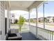 Inviting covered front porch with comfortable seating and views of the neighborhood street at 10106 E 59Th Pl, Denver, CO 80238