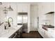 Well-equipped kitchen with stainless steel appliances, a center island, and custom cabinetry at 10106 E 59Th Pl, Denver, CO 80238