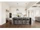 Spacious kitchen featuring a large center island with seating, stainless steel appliances, and ample storage at 10106 E 59Th Pl, Denver, CO 80238