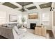 Cozy living room with a fireplace, coffered ceilings, and comfortable seating at 10106 E 59Th Pl, Denver, CO 80238