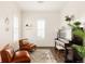 Bright living room with dark wood floors, leather chairs, a rug, and an upright piano at 10106 E 59Th Pl, Denver, CO 80238