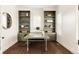 This office boasts built-in shelving, a modern desk, wood floors, and bright natural light at 10106 E 59Th Pl, Denver, CO 80238