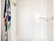 Bright, tiled shower with a modern shower head, sleek fixtures, and a decorative shower curtain at 10106 E 59Th Pl, Denver, CO 80238