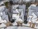 Aerial view of house and neighborhood in the snow at 3100 Rockbridge Dr, Highlands Ranch, CO 80129