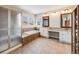 Bathroom with granite countertop, double sinks, and soaking tub at 3100 Rockbridge Dr, Highlands Ranch, CO 80129