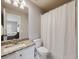 Bathroom with granite countertop, white cabinets and a shower/tub combo at 3100 Rockbridge Dr, Highlands Ranch, CO 80129