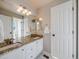 Bathroom with granite countertops, double sinks, and a shower at 3100 Rockbridge Dr, Highlands Ranch, CO 80129