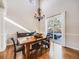 Bright dining room features a wooden table, chandelier, and sliding glass door leading to backyard at 3100 Rockbridge Dr, Highlands Ranch, CO 80129