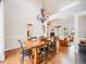 Farmhouse style dining room with wooden table, chandelier, and hardwood floors at 3100 Rockbridge Dr, Highlands Ranch, CO 80129