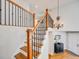 Elegant staircase with wooden railings and a chandelier at 3100 Rockbridge Dr, Highlands Ranch, CO 80129