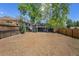 Spacious backyard with wood and chainlink fencing and mature trees providing shade at 1089 S Osceola St, Denver, CO 80219