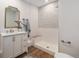 Modern bathroom featuring a walk-in shower, decorative tile, and a stylish vanity at 1089 S Osceola St, Denver, CO 80219