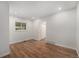 Bright and spacious bedroom showcasing hardwood floors, white walls, and a large window for ample natural light at 1089 S Osceola St, Denver, CO 80219