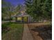 Charming single-story home with a welcoming yellow door, lush lawn, and mature trees at 1089 S Osceola St, Denver, CO 80219