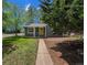 Charming single-story home with a welcoming yellow door, lush lawn, and mature trees at 1089 S Osceola St, Denver, CO 80219