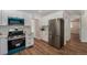 Modern kitchen featuring stainless steel appliances, white cabinets, and a stylish backsplash at 1089 S Osceola St, Denver, CO 80219