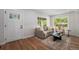 Inviting living room with a large window, stylish furniture, and hardwood floors creating a cozy atmosphere at 1089 S Osceola St, Denver, CO 80219