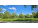 Open green space featuring a tranquil lake and mature trees at 1089 S Osceola St, Denver, CO 80219