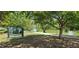 View of the Garfield Lake Park sign surrounded by lush greenery and mature trees at 1089 S Osceola St, Denver, CO 80219