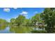 Scenic view of a tranquil pond surrounded by green trees reflecting in the still waters at 1089 S Osceola St, Denver, CO 80219
