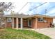 View of backyard with covered patio, grill and mature trees at 3632 Leyden St, Denver, CO 80207