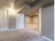 Finished basement featuring neutral carpet, recessed lights, and white bifold doors to a closet at 3632 Leyden St, Denver, CO 80207