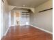 Spacious bonus room features hardwood floors, a bathroom, and built-in shelving at 3632 Leyden St, Denver, CO 80207