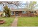 Charming brick home with a well-manicured lawn and inviting walkway at 3632 Leyden St, Denver, CO 80207
