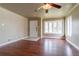 Bright living room with hardwood floors, ceiling fan, and a large bay window at 3632 Leyden St, Denver, CO 80207