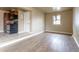 Living area with vinyl floors, white trim, kitchen access, and natural light at 3632 Leyden St, Denver, CO 80207