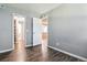 Bedroom featuring wood floors and a view into the hallway and another room at 447 S Memphis Way # 7, Aurora, CO 80017