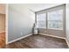 Bright bedroom with wood floors, two windows and an air conditioner unit at 447 S Memphis Way # 7, Aurora, CO 80017