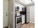 Efficient kitchen features stainless steel appliances, white cabinets, and wood-look flooring at 447 S Memphis Way # 7, Aurora, CO 80017