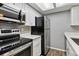 Compact kitchen showcases stainless steel appliances, white cabinets, and ample countertop space at 447 S Memphis Way # 7, Aurora, CO 80017