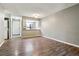 Comfortable living room featuring wood floors and an open layout to the kitchen and laundry area at 447 S Memphis Way # 7, Aurora, CO 80017
