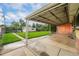 View of a covered patio overlooking a spacious yard with a shed at 2321 Lima St, Aurora, CO 80010