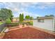 A cozy backyard featuring a rock garden, a wooden fence, and a detached garage at 2321 Lima St, Aurora, CO 80010