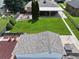 Aerial view of a landscaped backyard with lush lawn, fire pit, shed, and privacy fence at 2321 Lima St, Aurora, CO 80010