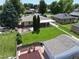 Aerial view of a landscaped backyard with lush lawn, fire pit, patio, and privacy fence at 2321 Lima St, Aurora, CO 80010