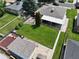 Aerial view of a landscaped backyard with lush lawn, shed, privacy fence, and patio at 2321 Lima St, Aurora, CO 80010