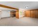 Unfurnished basement featuring carpeting and built-in bar area, perfect for entertaining and gatherings at 2321 Lima St, Aurora, CO 80010