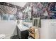 Stylish bathroom with floral wallpaper, a modern vanity, and patterned shower curtain for added privacy at 2321 Lima St, Aurora, CO 80010