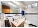 Tiled bathroom featuring a vanity, mirror, and updated fixtures at 2321 Lima St, Aurora, CO 80010
