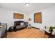 Well-lit bedroom featuring hardwood floors, a crib, and neutral decor for a cozy, comforting atmosphere at 2321 Lima St, Aurora, CO 80010