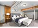 Basement bedroom featuring a comfortable bed, bedside lamps, and paneled walls for a cozy feel at 2321 Lima St, Aurora, CO 80010