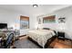 Comfortable bedroom featuring a queen bed, patterned rug, and hardwood floors for a restful retreat at 2321 Lima St, Aurora, CO 80010