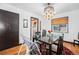 Well-lit dining area with a classic chandelier, dark wood table, and a comfortable space for Gathering meals at 2321 Lima St, Aurora, CO 80010