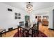Elegant dining room featuring a stylish chandelier, dark wood table, and seamless flow into the living area at 2321 Lima St, Aurora, CO 80010