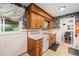 Efficient kitchen with wooden cabinetry, white countertops, and easy access to the dining area, ideal for cooking at 2321 Lima St, Aurora, CO 80010