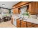 Well-maintained kitchen with wooden cabinets, stainless steel sink, and a breakfast table, perfect for casual meals at 2321 Lima St, Aurora, CO 80010